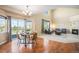 Dining area with hardwood floors, modern lighting, and sliding glass doors leading to the deck at 7624 Russell Ct, Arvada, CO 80007