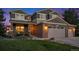 Charming home featuring a well-manicured lawn and a brick facade, complemented by a spacious three-car garage at 7624 Russell Ct, Arvada, CO 80007