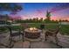 Outdoor fire pit area with stone patio and seating, perfect for entertaining at 7624 Russell Ct, Arvada, CO 80007