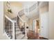 Elegant foyer showcases a grand staircase, hardwood floors, and an open layout, creating an inviting entrance at 7624 Russell Ct, Arvada, CO 80007