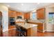 Functional kitchen features wooden cabinets, granite countertops, a center island, and modern appliances, perfect for cooking at 7624 Russell Ct, Arvada, CO 80007