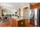 Modern kitchen with stainless steel appliances, granite countertops, and a center island with eat-in breakfast bar at 7624 Russell Ct, Arvada, CO 80007