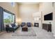 Bright living room with high ceilings, fireplace, and large windows offering plenty of natural light at 7624 Russell Ct, Arvada, CO 80007