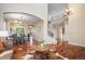 Spacious living area with hardwood floors, an arched entryway, and a grand staircase, ideal for entertaining at 7624 Russell Ct, Arvada, CO 80007