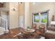 Bright living room with high ceilings, hardwood floors, and large windows, providing an open and airy feel at 7624 Russell Ct, Arvada, CO 80007