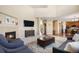 Open-concept living room featuring a fireplace, vaulted ceilings, and hardwood floors at 7624 Russell Ct, Arvada, CO 80007