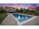 Backyard featuring a large in-ground swimming pool, a deck, and a spacious green lawn, perfect for entertaining at 7624 Russell Ct, Arvada, CO 80007