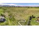 Scenic walking trail winds through a lush green hillside with mountain views and neighborhood homes at 7624 Russell Ct, Arvada, CO 80007