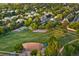 Overhead shot of a neighborhood park with a basketball court, baseball field and lush greenery at 3090 W 107 Pl # F, Westminster, CO 80031