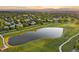 Aerial shot of a community golf course with a pond, with lush green grass and homes at 3090 W 107 Pl # F, Westminster, CO 80031