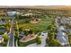 Aerial view of community park, baseball field, playground, and walking path surrounded by lush trees and landscape at 3090 W 107 Pl # F, Westminster, CO 80031