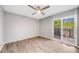An empty bedroom showcasing laminate wood floors, neutral walls, and sliding glass doors to a patio at 3090 W 107 Pl # F, Westminster, CO 80031
