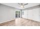 Bright bedroom has a ceiling fan, wood floor, and access to the outside through sliding glass doors at 3090 W 107 Pl # F, Westminster, CO 80031