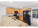 Well-equipped kitchen boasting granite countertops, stainless steel appliances, and wooden cabinets at 3090 W 107 Pl # F, Westminster, CO 80031