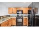 A detailed kitchen with stainless steel appliances, wooden cabinetry, and granite countertops at 3090 W 107 Pl # F, Westminster, CO 80031