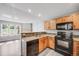 Bright kitchen featuring granite countertops, stainless steel appliances, and wooden cabinets at 3090 W 107 Pl # F, Westminster, CO 80031