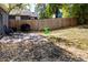 Cozy backyard featuring a patio, lawn, garden, ' playground and tall wooden fence at 4921 Beach Ct, Denver, CO 80221