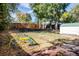 Large backyard with mature trees, a play structure, and a storage shed at 4921 Beach Ct, Denver, CO 80221