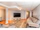 Relaxing basement area with cozy seating, a large TV, and a neutral-toned rug creates a comfortable entertainment space at 4921 Beach Ct, Denver, CO 80221