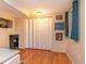 Basement area with a small office or workspace, featuring wood floors and a window for natural light at 4921 Beach Ct, Denver, CO 80221