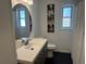 Modern bathroom with a sleek vanity, oval mirror, shiplap walls, and funny dog art at 4921 Beach Ct, Denver, CO 80221