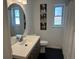 Bathroom with a modern vanity, black floors, and fun dog-themed artwork adds charm to this relaxing space at 4921 Beach Ct, Denver, CO 80221