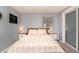 Serene bedroom with a large bed, matching nightstands, and sliding door closet, creating a cozy retreat at 4921 Beach Ct, Denver, CO 80221