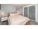 Serene bedroom with a large bed, matching nightstands, and sliding door closet, creating a cozy retreat at 4921 Beach Ct, Denver, CO 80221
