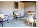 Relaxing covered porch with cozy seating, table with pumpkin, and wooden porch swing at 4921 Beach Ct, Denver, CO 80221