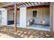 Inviting covered porch featuring seating, swing, and space for storage at 4921 Beach Ct, Denver, CO 80221
