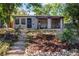 Charming one-story home featuring a covered porch swing, xeriscaping, and inviting curb appeal at 4921 Beach Ct, Denver, CO 80221