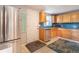 Functional kitchen with stainless steel appliances, wood cabinets, tile backsplash, and convenient side door access at 4921 Beach Ct, Denver, CO 80221