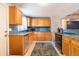 Bright kitchen with stainless steel appliances, wood cabinets, granite countertop, and view into adjacent room at 4921 Beach Ct, Denver, CO 80221