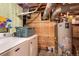Unfinished basement laundry area featuring a modern washer, dryer, and water heater at 4921 Beach Ct, Denver, CO 80221