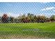 A park playground area is seen through a fence, showcasing a variety of colorful and engaging play structures at 4921 Beach Ct, Denver, CO 80221