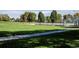 Scenic view of a community park featuring lush green grass, walking paths, and recreational baseball field at 4921 Beach Ct, Denver, CO 80221