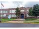 Classic brick school building featuring traditional architecture and inviting blue doors under an arched entryway at 4921 Beach Ct, Denver, CO 80221