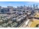 Aerial view of a city neighborhood, showcasing townhomes and the city skyline in the background at 1438 Little Raven St # 301, Denver, CO 80202