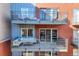Exterior view of multiple private balconies with seating and barbecue setups at 1438 Little Raven St # 301, Denver, CO 80202