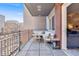 Outdoor balcony with comfortable seating, a small table, and views of the surrounding neighborhood at 1438 Little Raven St # 301, Denver, CO 80202