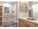 Bright bathroom featuring a tub with tiled surround and a vanity with a stainless steel sink at 1438 Little Raven St # 301, Denver, CO 80202