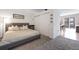 Inviting bedroom with a gray headboard, plush carpet, and adjacent bathroom access at 1438 Little Raven St # 301, Denver, CO 80202