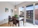 Bright dining area features a wooden table, chairs, and sliding glass doors to the outdoor balcony at 1438 Little Raven St # 301, Denver, CO 80202