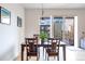 This dining area has a wooden table with chairs, a globe light fixture, and access to the balcony at 1438 Little Raven St # 301, Denver, CO 80202