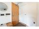 Entryway with wood-look flooring, a round mirror, and hooks for hanging items at 1438 Little Raven St # 301, Denver, CO 80202