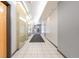 Hallway with tile flooring, bright lighting, and doors leading to various units at 1438 Little Raven St # 301, Denver, CO 80202