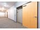 Hallway view to elevator with grey carpet and tan door at 1438 Little Raven St # 301, Denver, CO 80202