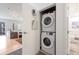 Laundry closet containing a stacked washer and dryer, with a glimpse into the living area at 1438 Little Raven St # 301, Denver, CO 80202