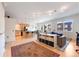 Open-concept living area with hardwood floors, kitchen, and dining space filled with natural light at 1438 Little Raven St # 301, Denver, CO 80202