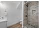 Bathroom with a modern shower featuring gray-toned tiles and stylish black fixtures at 2815 W 52Nd Ave, Denver, CO 80221